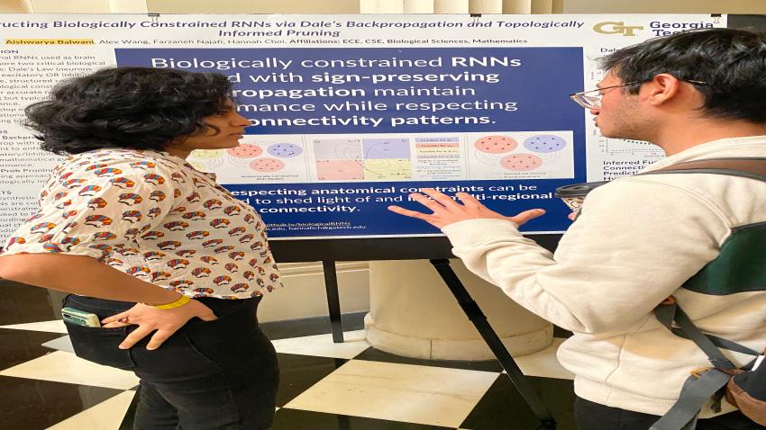 Aishawarya Balwani (on left), a Ph.D. scholar in electrical and computer engineering, answers questions about her research during the Frontiers in Science poster session.