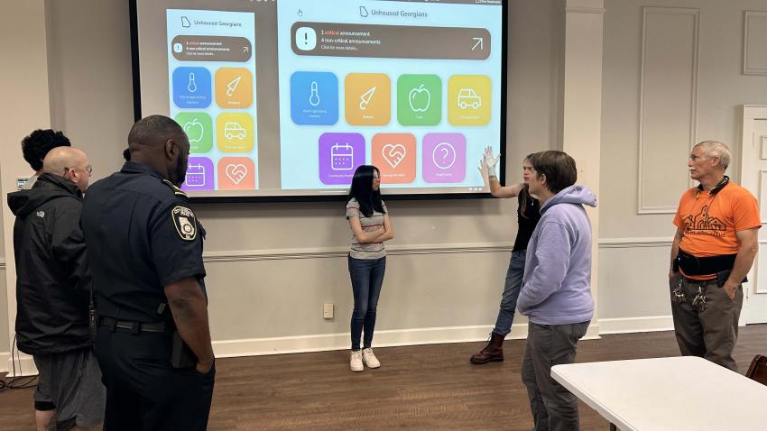 The student team presents the app to community leaders in DeKalb County. Photos by Gregory White.