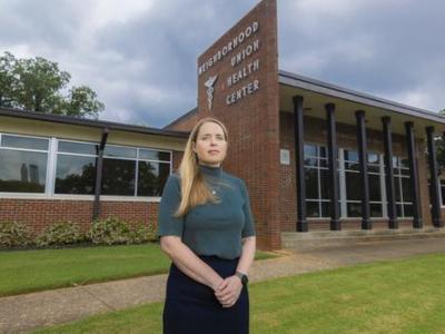 woman standing in front of brick building