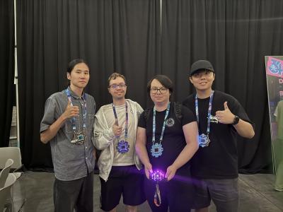 A group of four people standing inside a convention hall. 