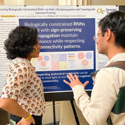 Aishawarya Balwani (on left), a Ph.D. scholar in electrical and computer engineering, answers questions about her research during the Frontiers in Science poster session.