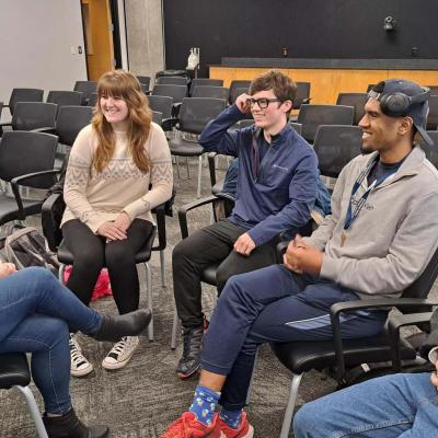 Whitlow meets with a student group after class to discuss their startup around agriculture equipment manufacturing. From left to right: Whitlow, CS majors Alexa Shoop, Joseph Britt, Roderic Parson, and Daniel Arias.