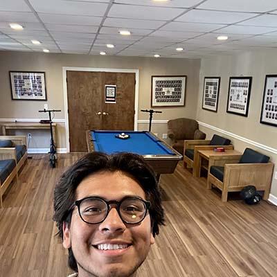 Yamil Quispe stands in one of the house’s recreation areas, which offers balance of work and play for residents. Photos by Yamil Quispe.